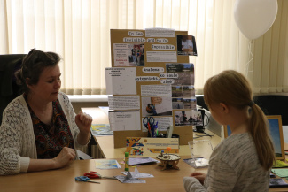 A child and a woman in a science workshop setting