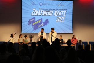 A group of children and young scientists on stage