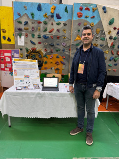A man at a stand during a science conference