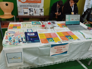 A table with brochures and exhibits during a science conference