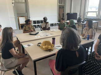 A workshop group sitting around a seminar table
