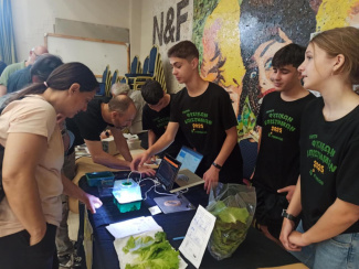 students presenting a science project at a stand
