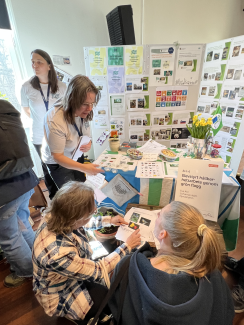 Eva Ahl from Svandammsskolan, Nynäshamn, shows two visitors how to solve their challenges about nature and environment. 