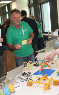 A teacher at a workshop table with experiments