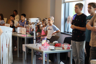 A group of students in a seminar room at the opening of a science festival