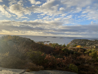 A panoramic view of a bay and a blue sky with white clouds