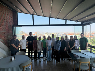 A seminar group photo in front of a panorama window