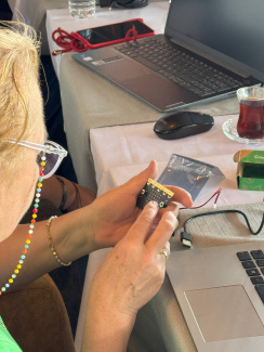 A workshop participant with a micro:bit sensor unit